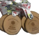 Wooden medals engraved with British Biathlon and Leeds Biathlon are attached to white ribbons printed with 2026. Some medals are labelled U21 Distance Winner and Masters Distance Winner.