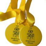 Two yellow sports day winner medals with yellow ribbons, each featuring a trophy graphic and the text PAPIER, SPORTS DAY winner, and the years 2020 and 2026.