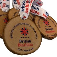 Wooden round medals with “British Biathlon British Championships Champions U21 – Runner-up” printed on them, each attached to a white ribbon with the British Biathlon logo and text.